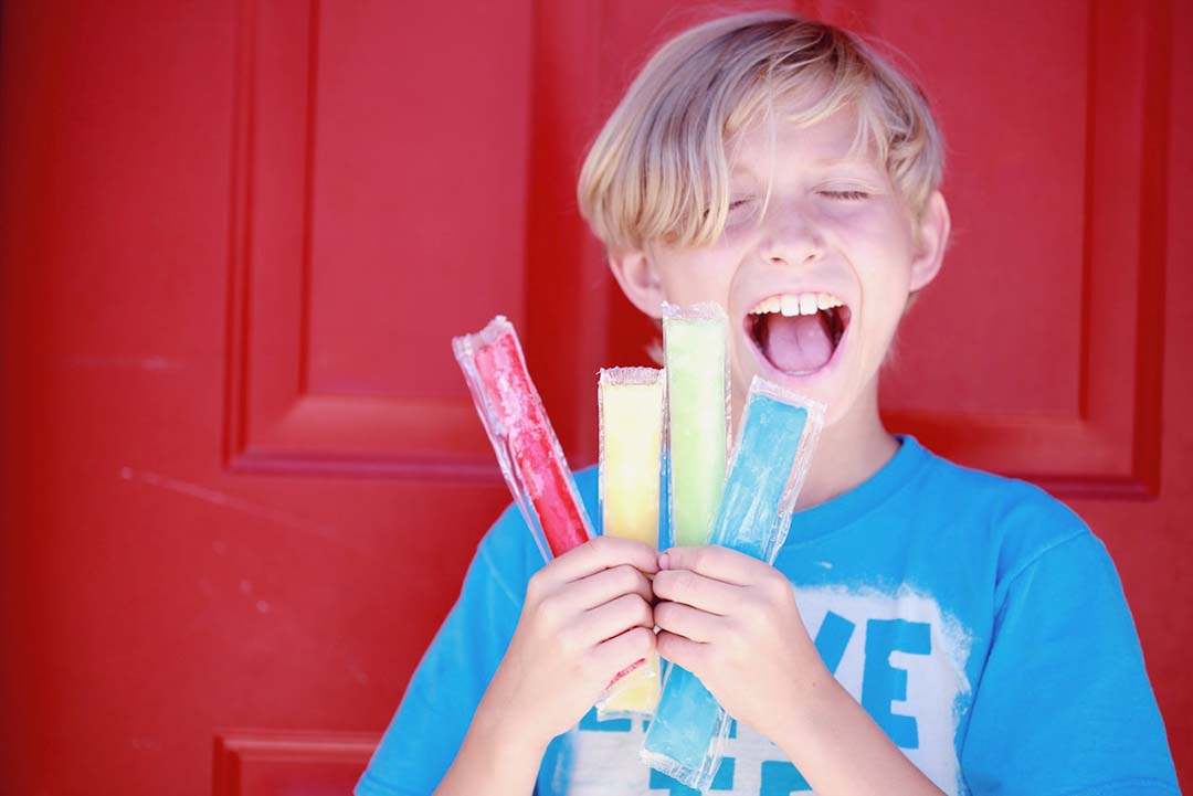 Child with four ice pops